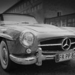 Classic vintage Mercedes convertible captured in black and white with sleek design.